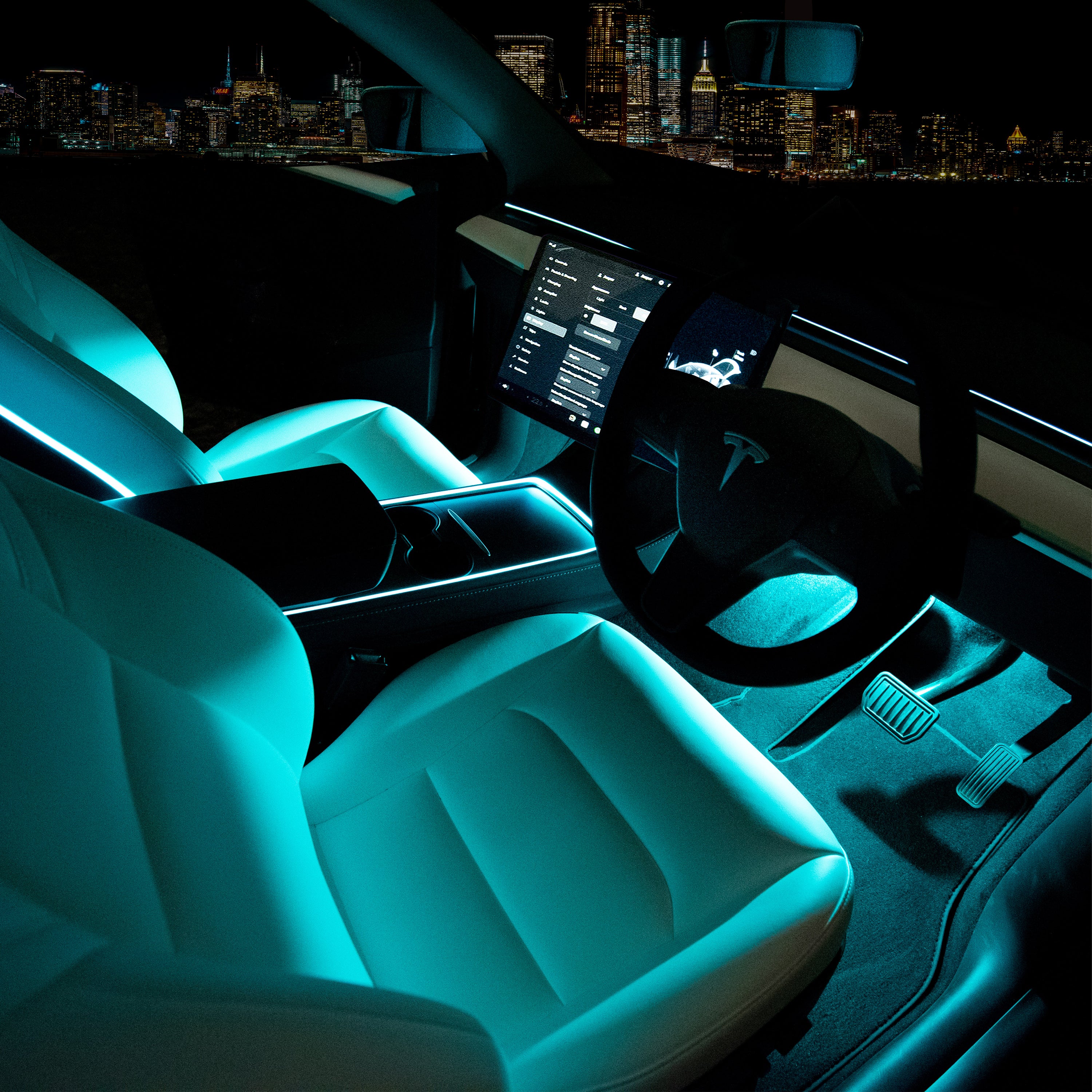Interior view of a Tesla vehicle showcasing the Add-On RGB lighting kit, with a blue light illuminating the dashboard and seats.