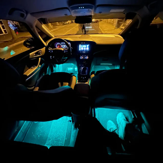 Universal car interior ambient lighting in cyan. Full cabin coverage including front and rear seat footwell lights for a complete 360-degree color experience.